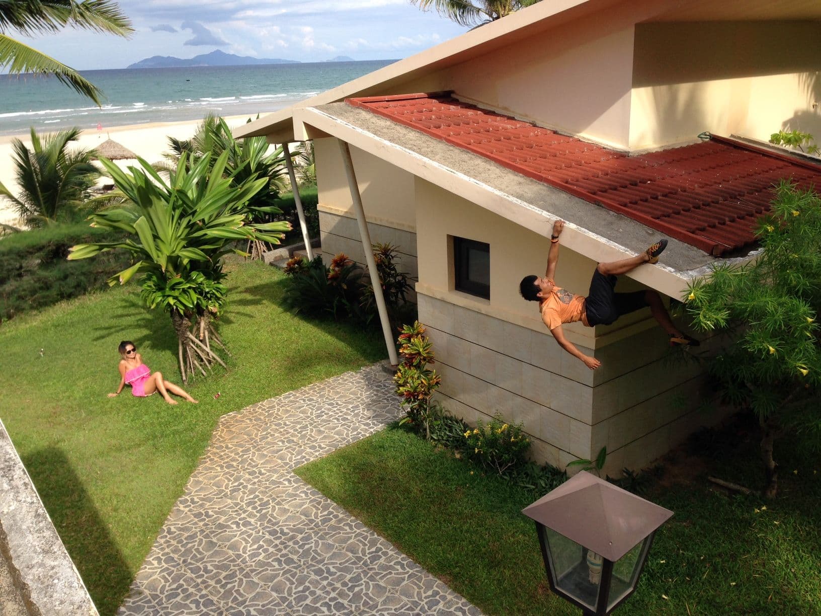 A Vietnamese climber doing buildering on a villa in Danang