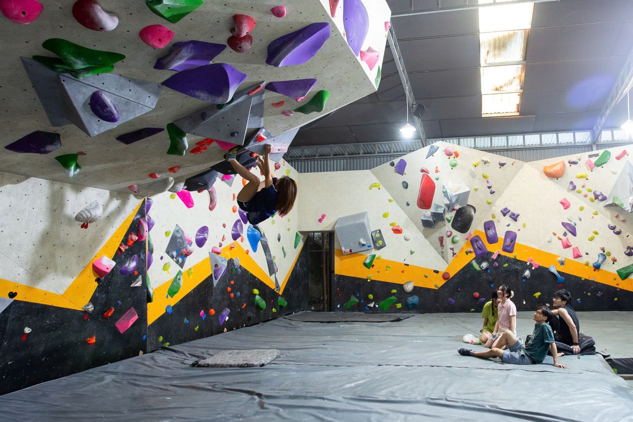 a group of vietnamese climbers increasing their fitness with bouldering